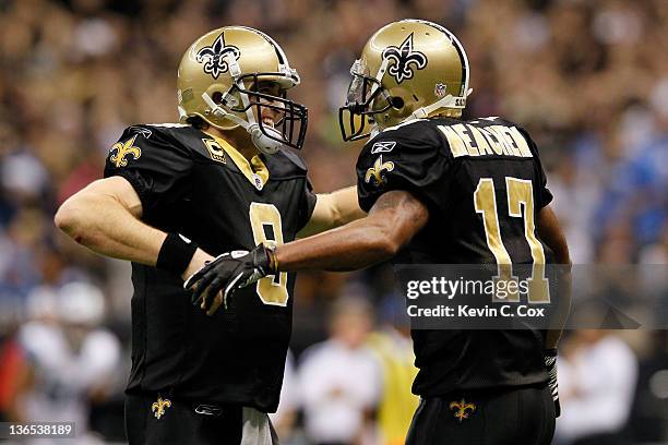 Drew Brees and Robert Meachem of the New Orleans Saints celebrate after their touchdown in the fourth quarter against the Detroit Lions during their...
