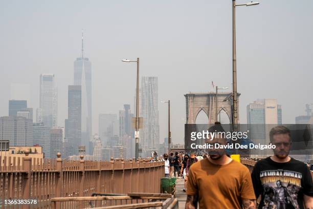 Smoke from wildfires in Canada shrouds the Freedom Tower seen from the Brooklyn Bridge on June 30, 2023 in New York City. The eastern U.S. Is once...