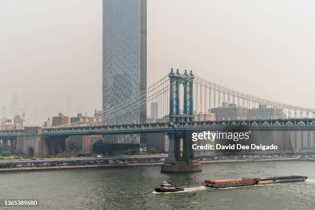 Smoke from wildfires in Canada shrouds lower Manhattan on June 30, 2023 in New York City. The eastern U.S. Is once again experiencing air quality...