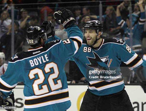 Brent Burns of the San Jose Sharks celebrates his power play goal at 19:51 of the second period along with Dan Boyle in their game against the...