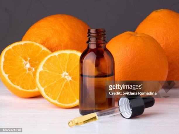 bottle with essential oils,  dropper with oil. fresh oranges. - aromatherapy oil stockfoto's en -beelden
