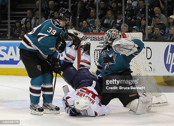 Logan Couture and Antti Niemi of the San Jose Sharks combine to stop Jeff Halpern of the Washington Capitals at the HP Pavilion at San Jose on...