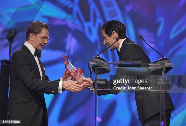 Actor Adrien Brody presents the International Star Award to actor Gary Oldman onstage during The 23rd Annual Palm Springs International Film Festival...