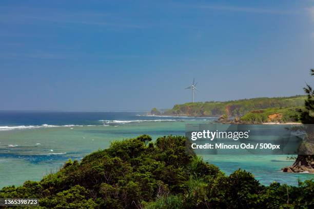 scenic view of sea against sky - okinawa blue sky beach landscape stockfoto's en -beelden
