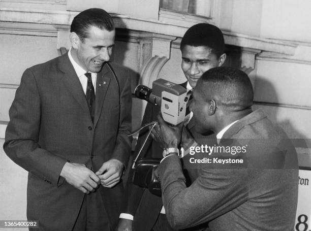 Djalma Santos from Brazil uses a cine camera to film team mates Lev Yashin of the Soviet Union and Eusebio of Portugal before facing England in an...