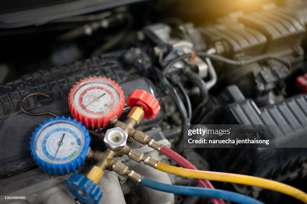 Car engine inspection tool with inspection and installation of car air conditioning system in the garage.