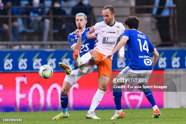 Valere Germain of Montpellier fights for the ball with Frédéric Gilbert of RC Strasbourg during the Ligue 1 Uber Eats match between RC Strasbourg and...