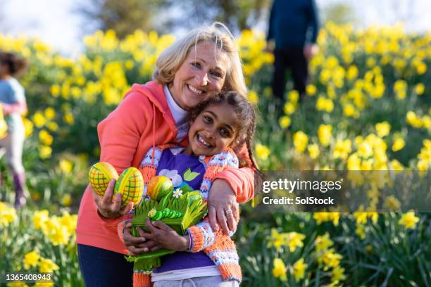 easter hugs with grandmother! - easter egg hunt outside stock pictures, royalty-free photos & images