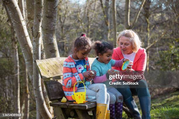 easter sunday with grandma! - easter egg hunt outside stock pictures, royalty-free photos & images