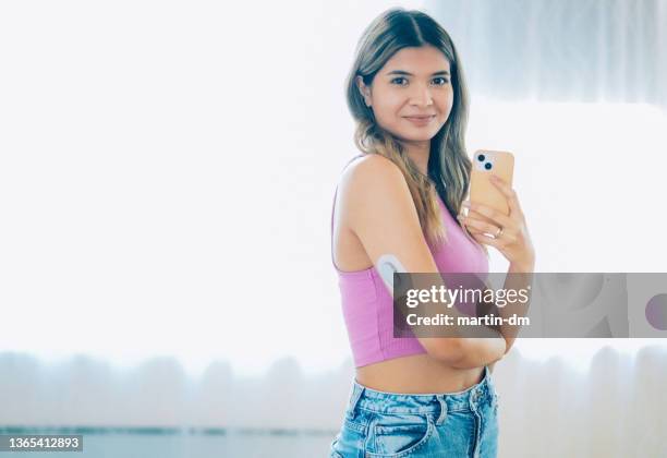 day in the life of young woman with type 1 diabetes - continuous glucose monitor stock pictures, royalty-free photos & images