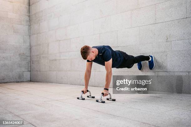 young man doing push-ups outdoors - press ups stock pictures, royalty-free photos & images