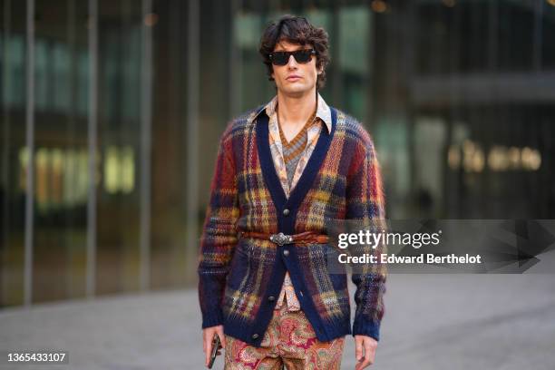 Guest wears sunglasses, a brown and gray striped V-neck wool pullover, a pale orange and gray print pattern shirt from Etro, a burgundy / yellow /...