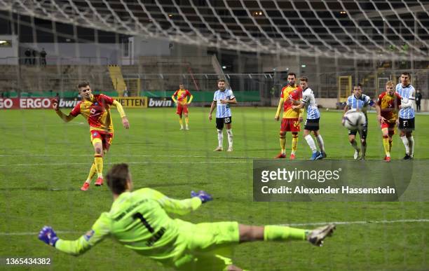 Marvin Wanitzek of Karlsruher SC scores their team's first goal from the penalty spot past Marco Hiller of TSV 1860 Muenchen during the DFB Cup round...