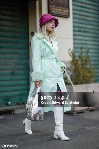 Guest wears a purple shiny vinyl bob hat, a white latte turtleneck pullover, a pale pink and purple print pattern tights, pale green shiny leather...
