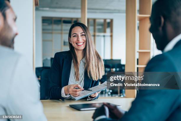 business persons having meeting in an office. - business meeting customer service stock pictures, royalty-free photos & images