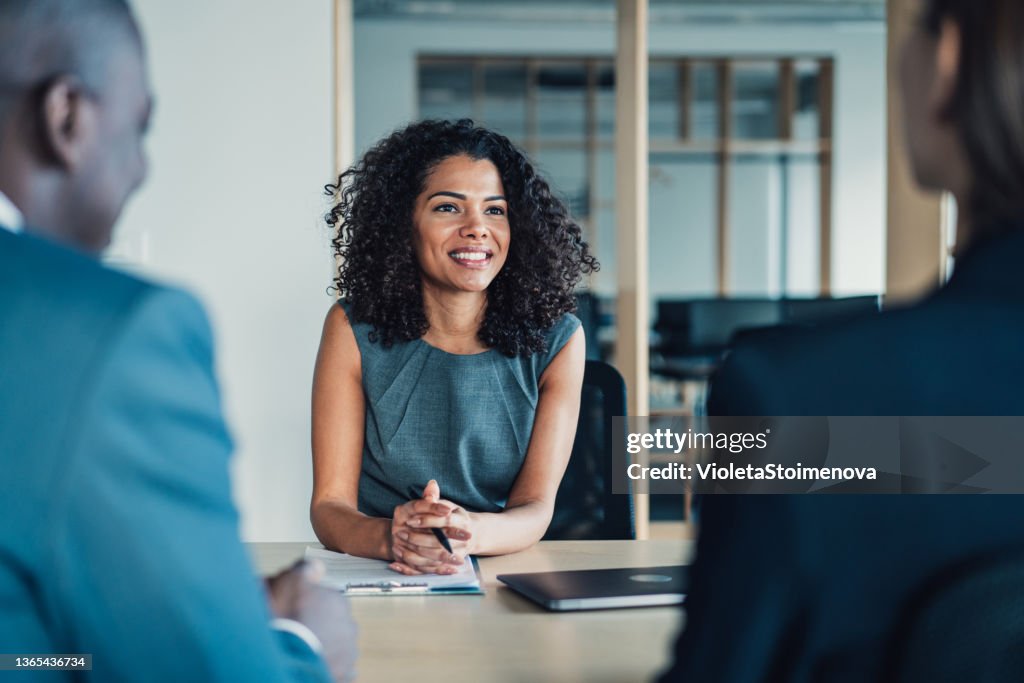 Group of business persons talking in the office.