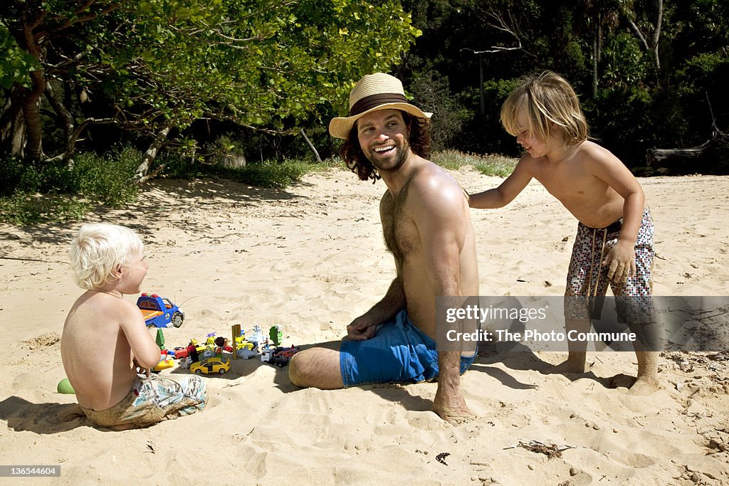 Father with his two sons at the beach
