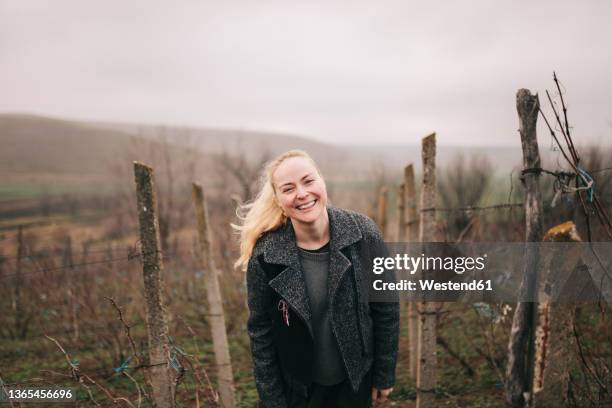 smiling farm worker wearing jacket at vineyard - martisor stock pictures, royalty-free photos & images