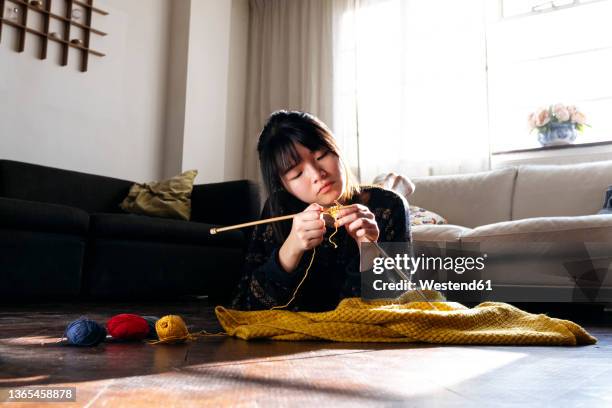 woman knitting and relaxing on floor at home - stitch stock pictures, royalty-free photos & images