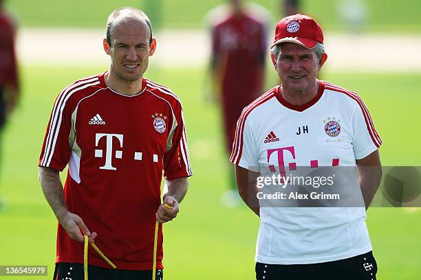 Head coach Jupp Heynckes and Arjen Robben look on during a training session of Bayern Muenchen at the ASPIRE Academy for Sports Excellence on January...