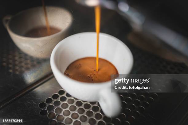 espresso machine pulling a shot in white mug stock photo - caffeine molecule stock pictures, royalty-free photos & images