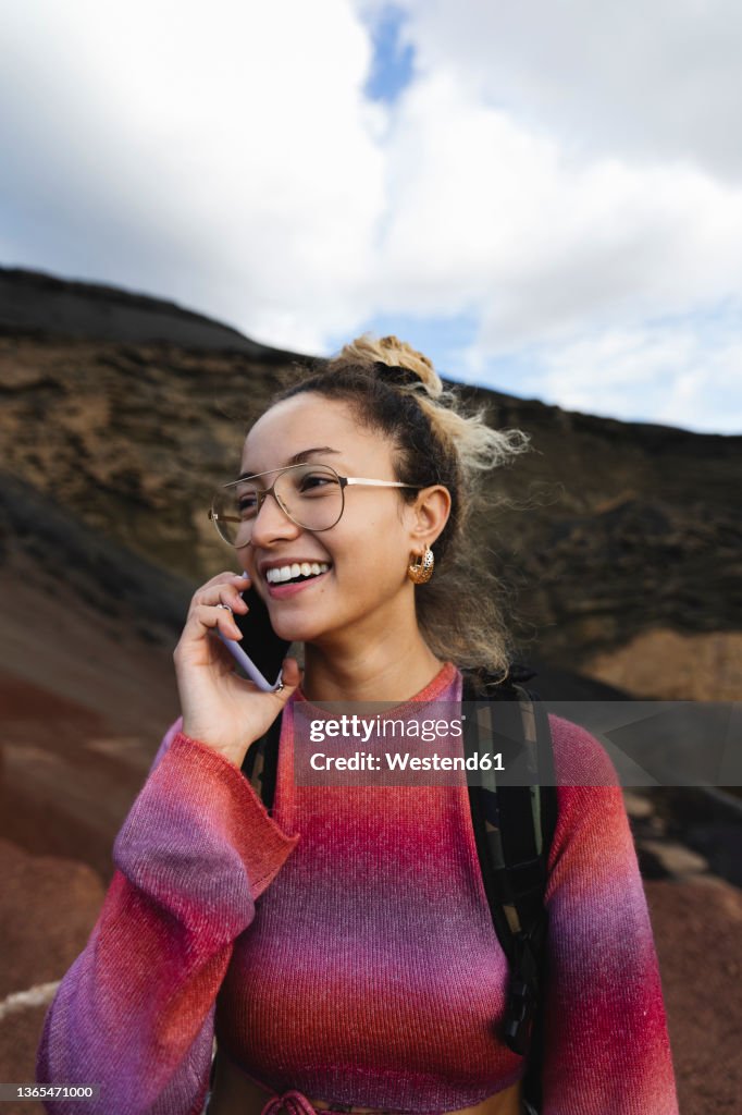 Smiling woman talking on mobile phone