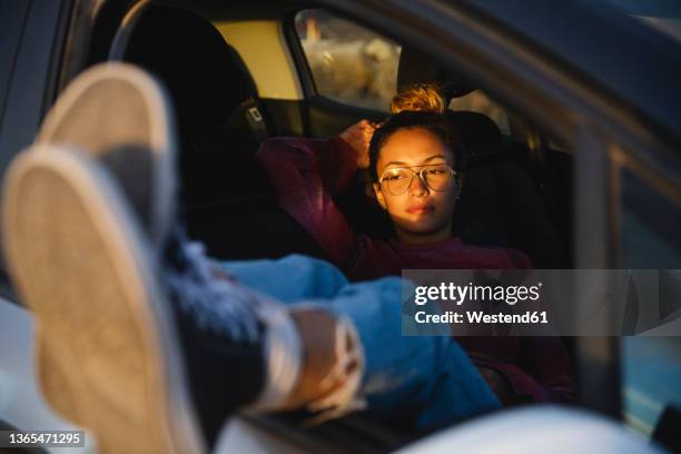 young woman resting in car at sunset - feet on table stock pictures, royalty-free photos & images