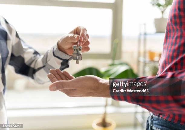 real estate agent giving house key to new home buyer - agent and handing keys stock-fotos und bilder