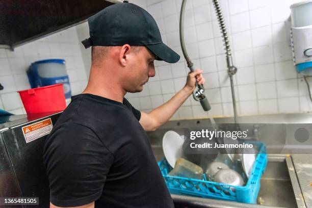 hispanic dishwasher at work - washing dishes restaurant stock pictures, royalty-free photos & images