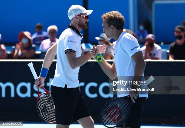 Jamie Murray of Great Britain and Bruno Soares of Brazil compete in their first round doubles match against James Duckworth of Australia and Marc...