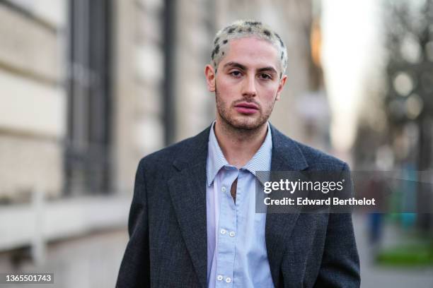 Alejandro Acero wears an oversized gray blazer jacket, a blue shirt, outside the Bluemarble show, during Paris Fashion Week - Menswear F/W 2022-2023,...