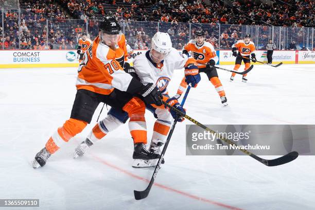 Rasmus Ristolainen of the Philadelphia Flyers and Oliver Wahlstrom of the New York Islanders challenge for the puck during the third period at Wells...