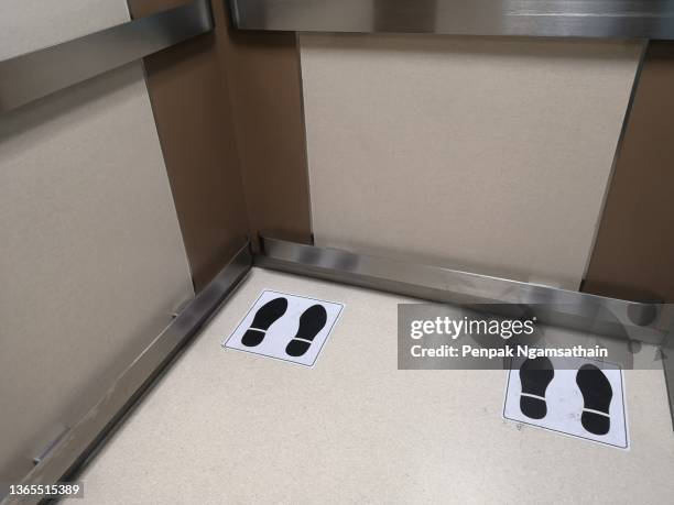 position symbol in the elevator social distancing, stainless​ steel shockproof on the wall - social distancing elevator stock pictures, royalty-free photos & images