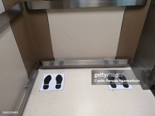 position symbol in the elevator social distancing, stainlesss​ steel shockproof on the wall - social distancing elevator stock pictures, royalty-free photos & images