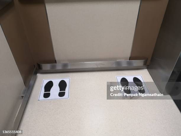 position symbol in the elevator social distancing, stainlesss​ steel shockproof on the wall - social distancing elevator stock pictures, royalty-free photos & images