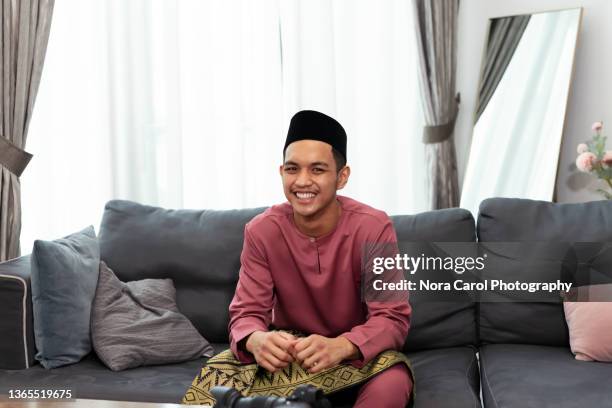 young man wearing malay traditional costume during hari raya celebration - handsome muslim men stock pictures, royalty-free photos & images