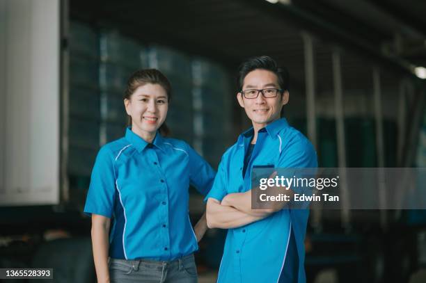 asian chinese warehouse distribution center manual workers looking at camera smiling - chinese ethnicity stock pictures, royalty-free photos & images