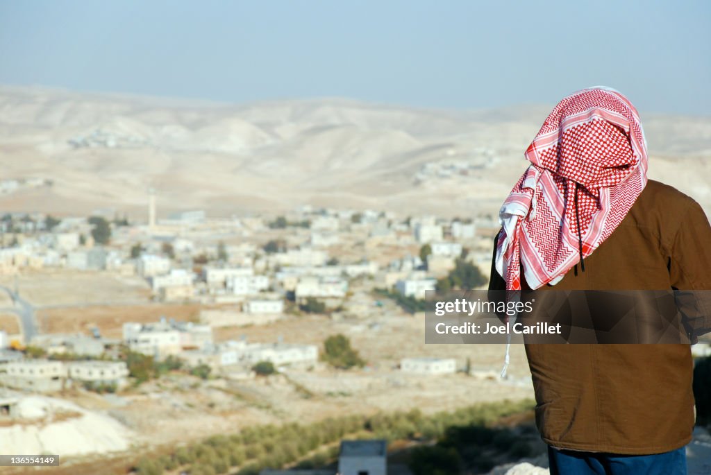 Palestinian man looking at West Bank landscape from the Herodian