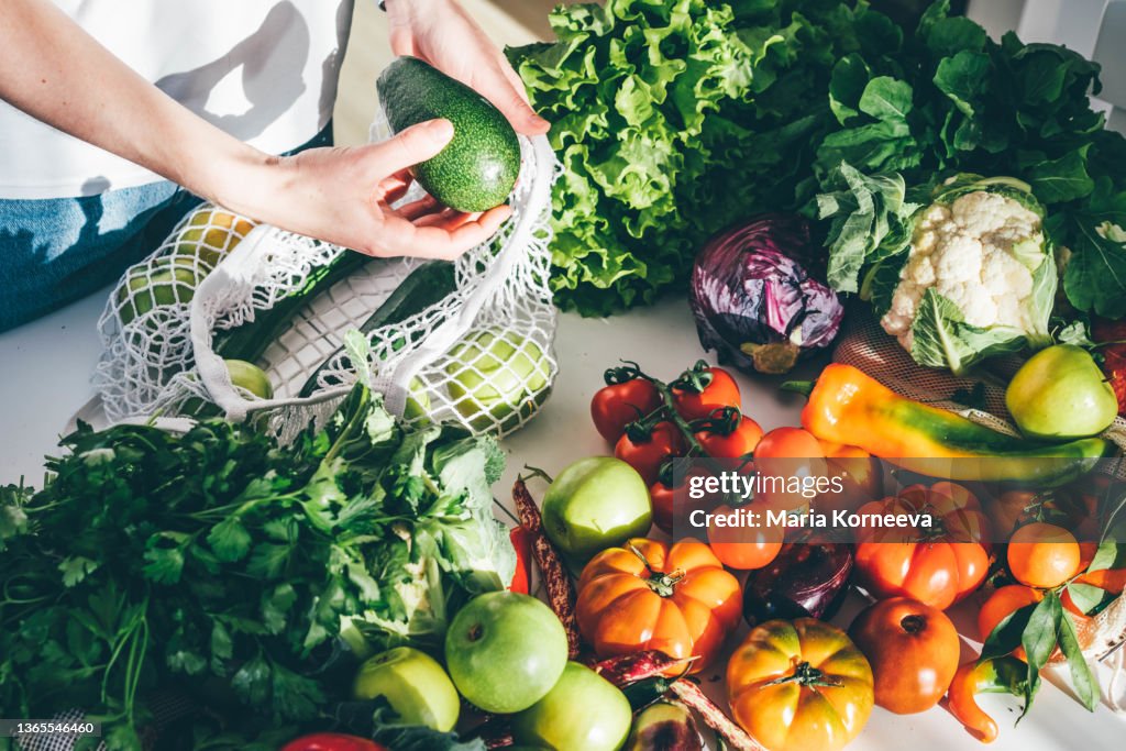 Woman takes fresh organic vegetables