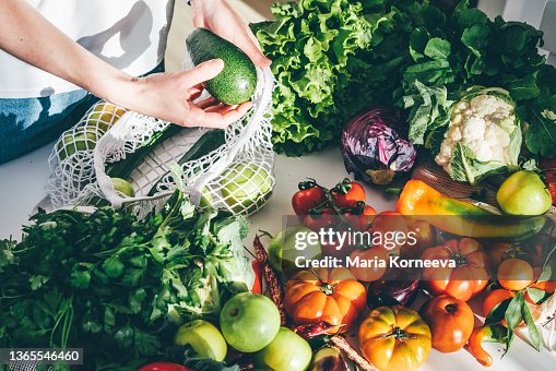 Woman takes fresh organic vegetables Woman takes fresh organic vegetables