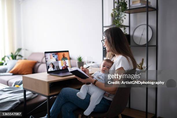 multi-tasking mom having a work meeting while looking after her baby son. - working mum stock pictures, royalty-free photos & images
