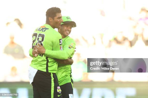 Gurinder Sandhu of the Thunder celebrates with teammate Usman Khawaja after dismissing Cameron Boyce of the Renegades and winning the Men's Big Bash...