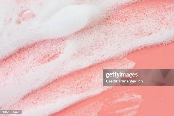 macrophotography of  beauty product foam soap on pastel pink coral rose color background. - foam material stockfoto's en -beelden