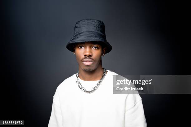 handsome young man wearing white sweatshirt - silver hat stock pictures, royalty-free photos & images