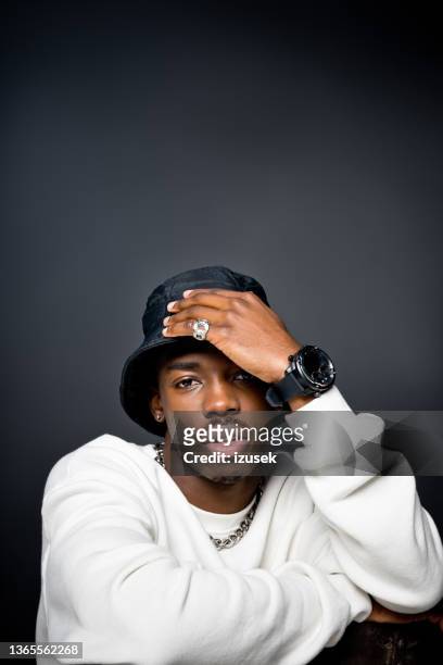 handsome young man wearing white sweatshirt - rapper chain stock pictures, royalty-free photos & images