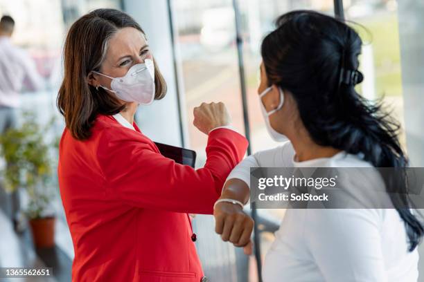 business women greeting one another - businesswoman mask stock pictures, royalty-free photos & images