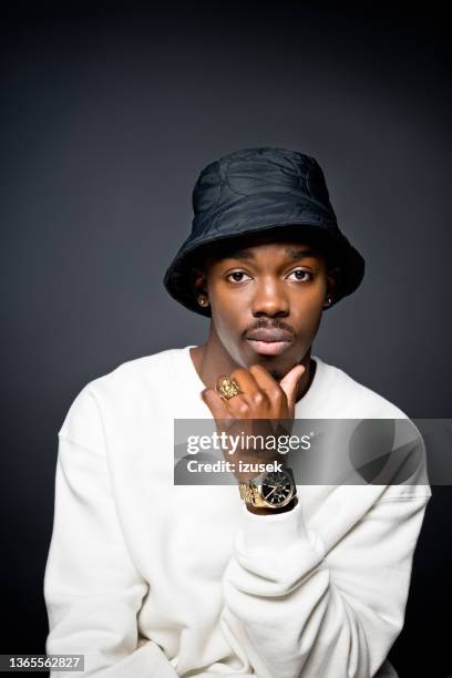 handsome young man wearing white sweatshirt - white rapper stock pictures, royalty-free photos & images