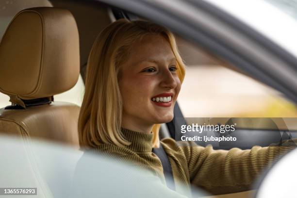 cute teenager driving her brand new car - car sharing stock pictures, royalty-free photos & images