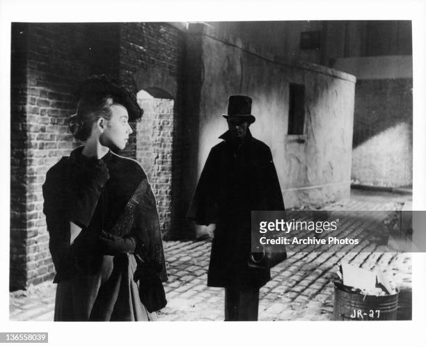 Unknown actress looking back at a man following her in a scene from the film 'Jack The Ripper', 1959.