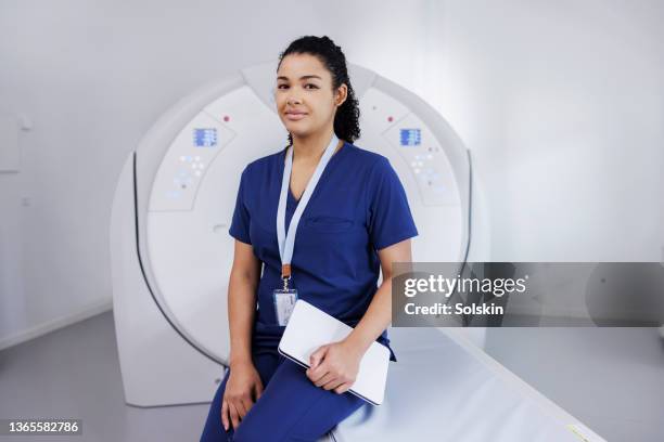 female healthcare worker in medical scanner room - radiotherapy stock pictures, royalty-free photos & images